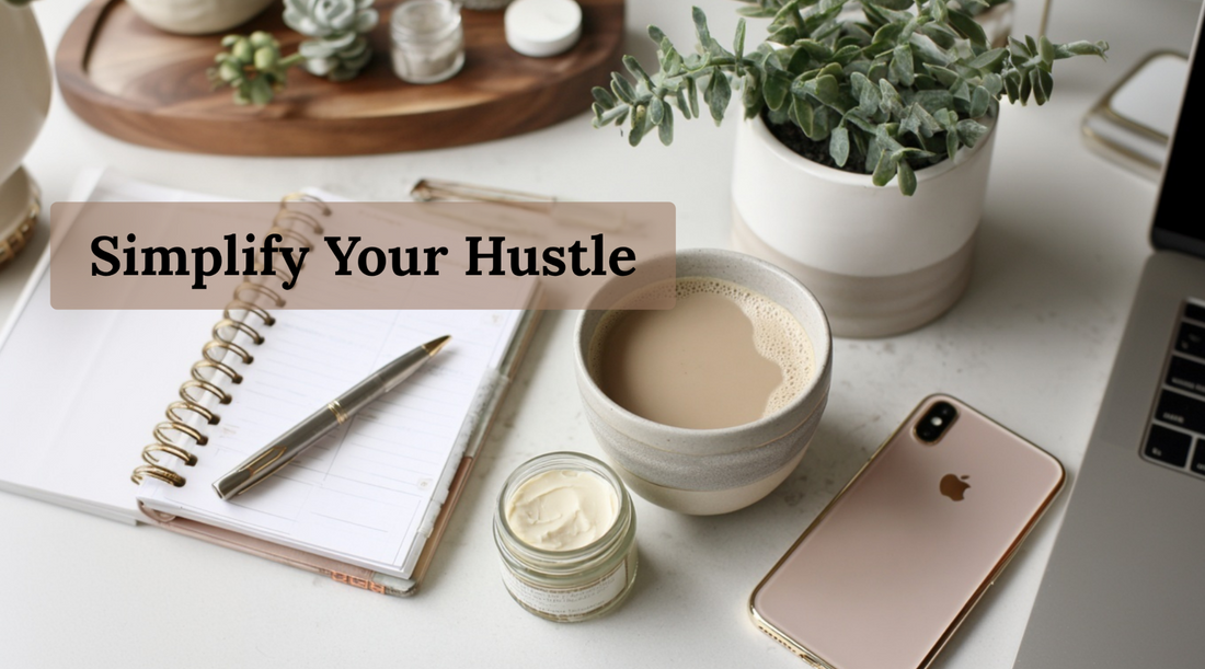 Flat lay of a notebook, pen, cup of coffee, small tallow jar, iPhone, and potted plant with the text “Simplify Your Hustle.”