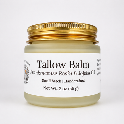 A frosted jar with a gold lid and white label on a light background