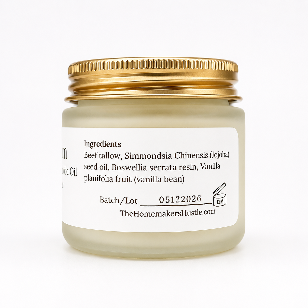 A frosted jar with a gold lid and white label on a light background
